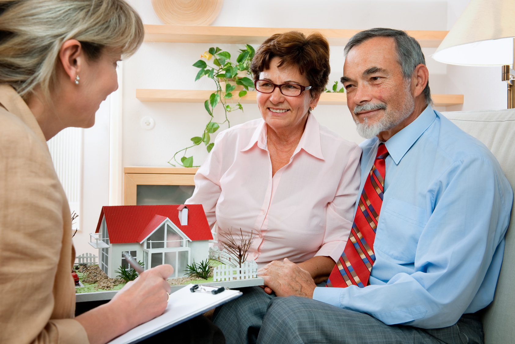 Couple discussing with real estate agent or architect