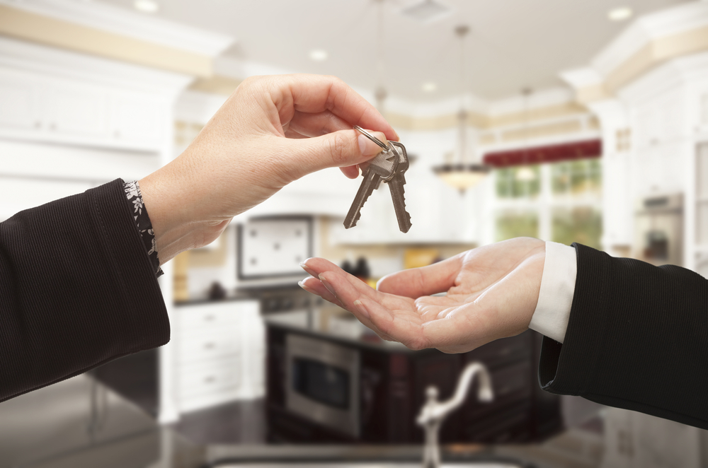 most-out-of-open-house Woman handing keys to buyer