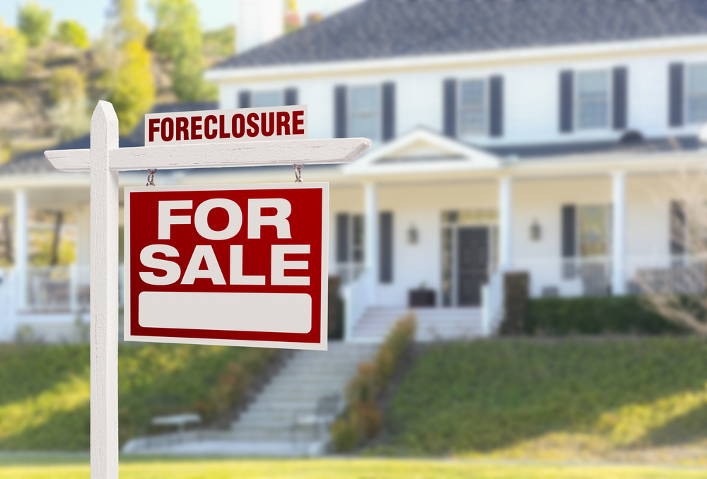 buying-bank-owned-property Foreclosure sign in front of home